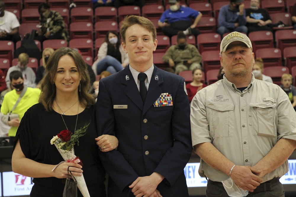 ROTC senior with parents being recognized for senior night 2021